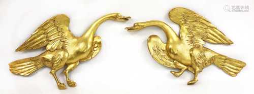 A pair of carved and gilded softwood swans,