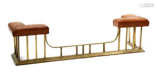 A brass and leather upholstered club fender,