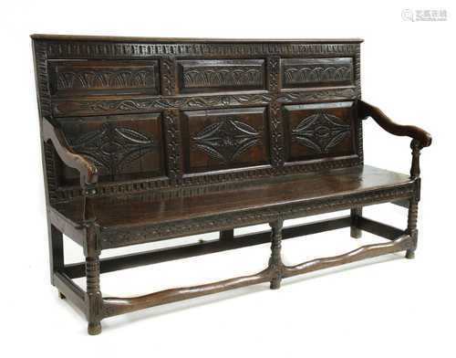 A carved oak settle,