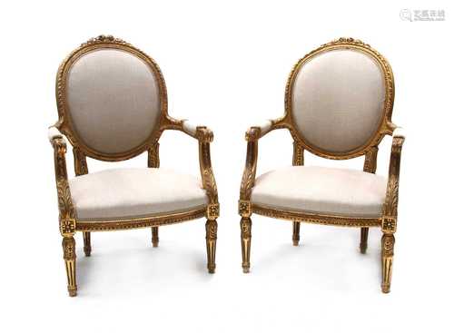 A pair of Continental giltwood open armchairs,