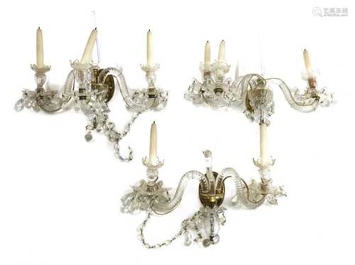 A pair of neoclassical-style three-branch wall lights,