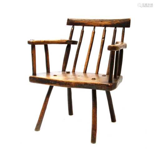 A primitive fruitwood stick back armchair,