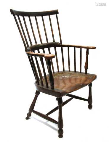 An ash and elm comb back Windsor armchair,