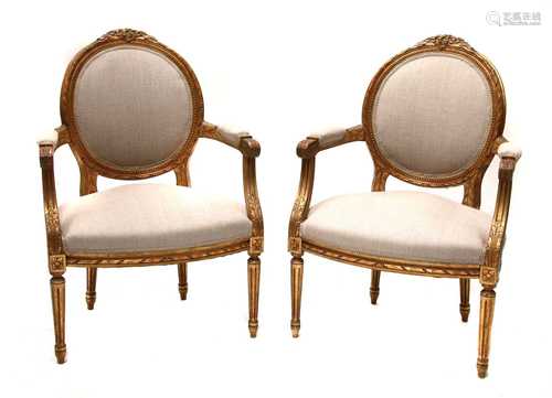 A pair of giltwood open armchairs,