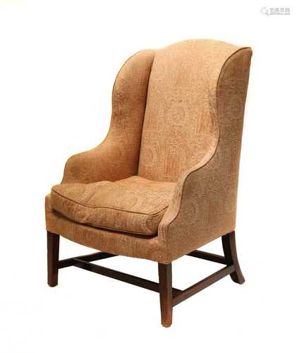 A George III mahogany wingback armchair,