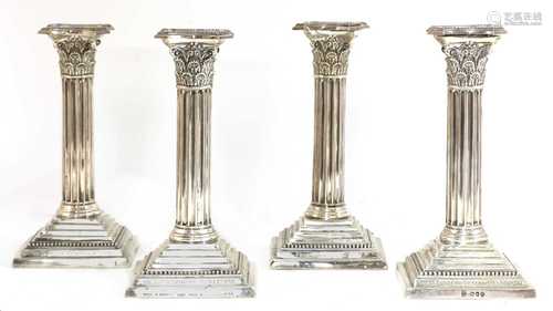 A set of four silver candlesticks,