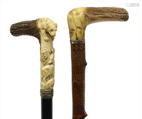 Two carved antler-handled walking sticks,