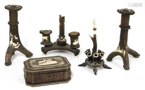 A pair of German carved antler tripod candlesticks, and three carved desk items