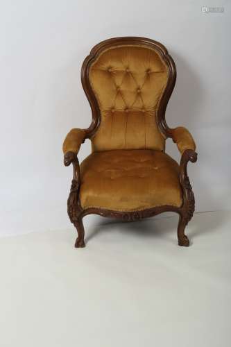 A Victorian walnut armchair, with moulded frame and carved eagle heads to the arm terminations,