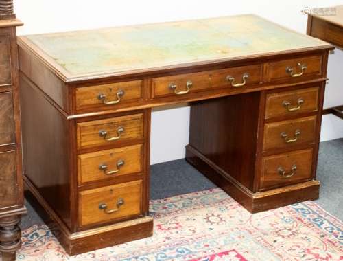 A late 19th Century mahogany twin-pedestal desk, stamped W M Morris to the drawers,