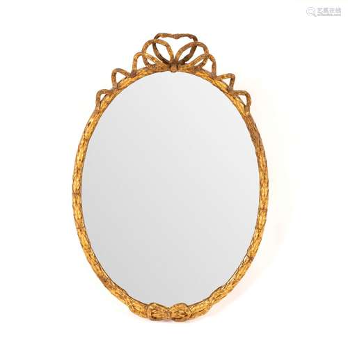 An oval gilt framed mirror with ribbon-tie to crest,