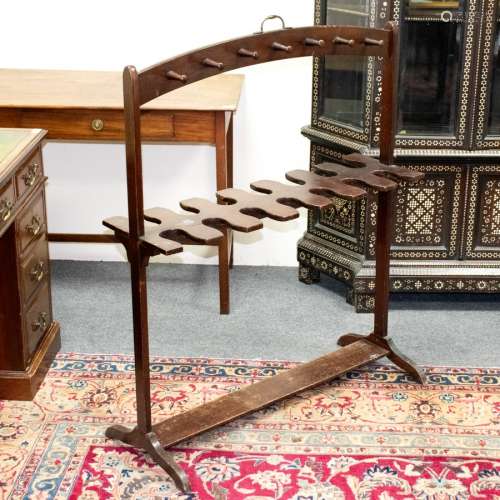 A George III mahogany boot rack, circa 1800, the hooped top and rack on trestle supports, 46cm x 35.