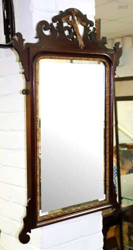 A George II style mahogany fret framed mirror, inlaid a shell and a gilt phoenix crest,