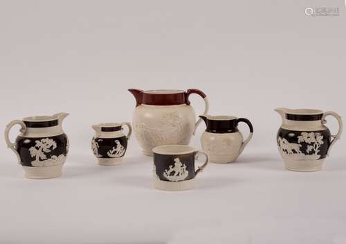 Four 19th Century jugs with raised decoration of hunting scenes, cherubs etc.