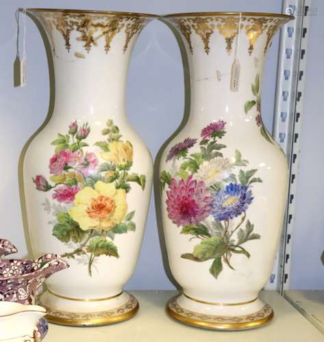 A pair of French porcelain baluster vases, painted bouquets of flowers,