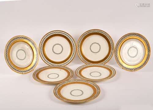 Seven Minton plates with gilt borders and interlacing trails of leaves, retailed by Soane & Smith,