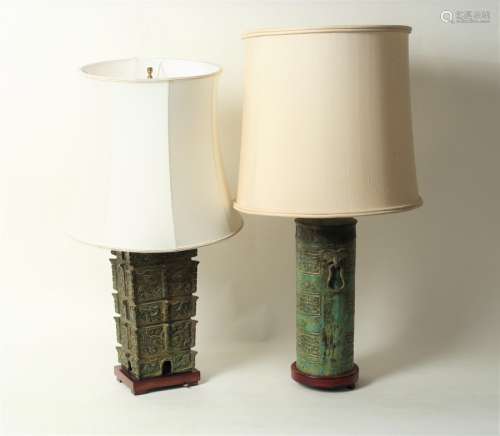 Two Chinese table lamps of archaistic bronze form, each on wooden stand and with shade,