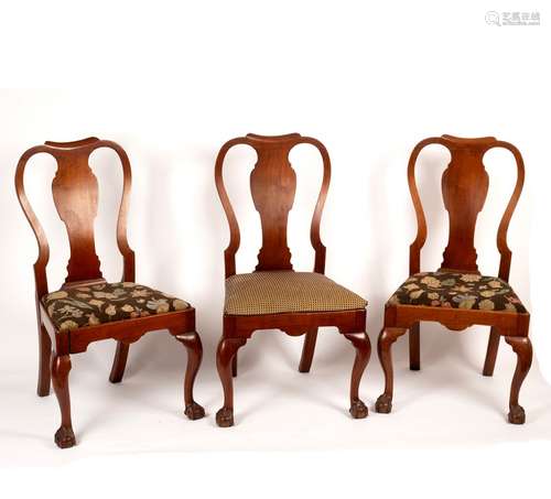 A set of three George I style walnut dining chairs with solid vase shaped splats and drop-in seats