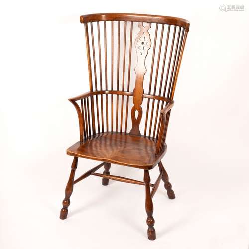 A Windsor type comb back chair with elm seat on turned legs, by Glenister,