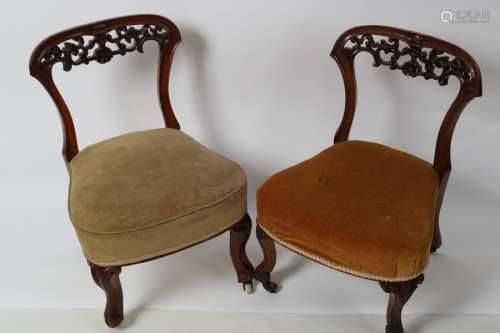 A pair of Victorian walnut nursing chairs, one with brass castors,