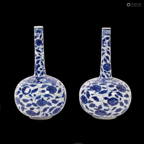 A pair of Chinese blue and white floral bottle vases, Kangxi, of globe and shaft form,