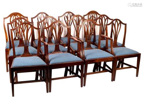 A matched set of twelve splat back dining chairs with trap seats on square tapering front legs,