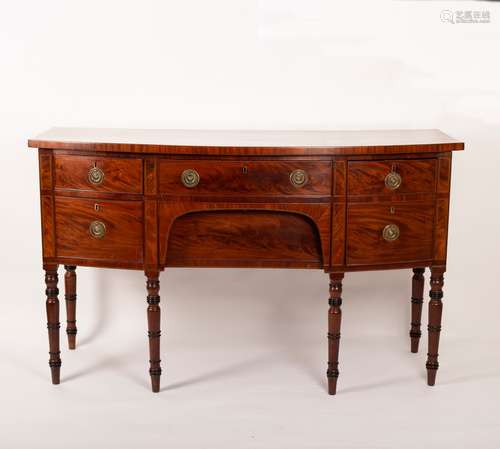 A George III mahogany bowfront sideboard on turned tapering legs,