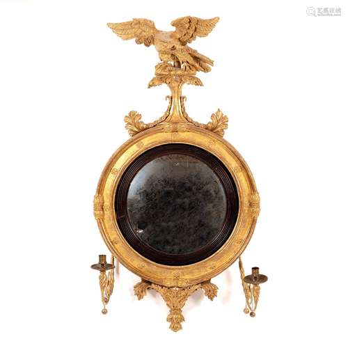 A Regency convex mirror in gilt frame with eagle surmount and two candle sconces,