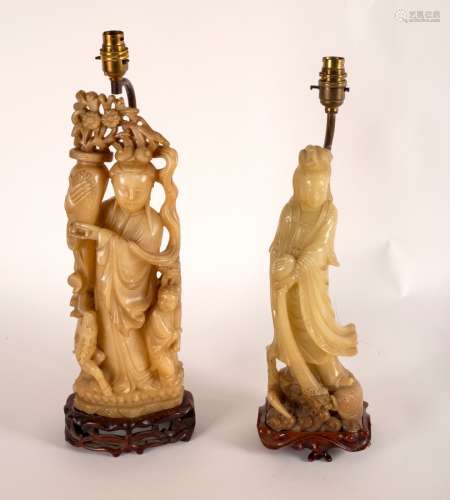 A Chinese soapstone figure of Guanyin pouring a vase of water into the waves, 35.
