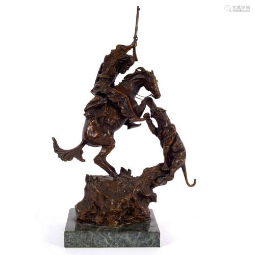 After Frederic Remington, a bronze model of an Indian attacking a panther on horseback,