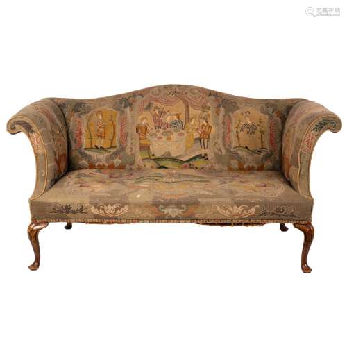 An 18th Century style settee with needlework upholstery, on carved walnut cabriole legs,