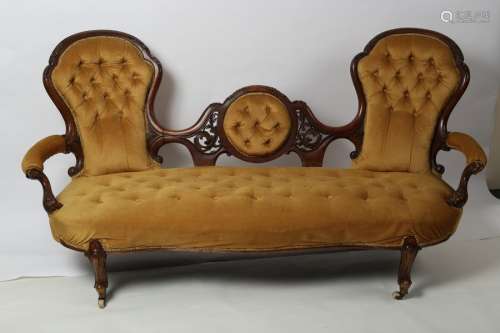 A Victorian walnut two chair back settee,