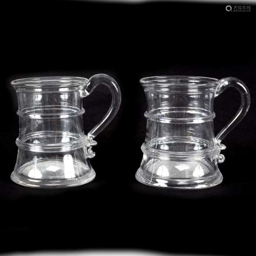 A pair of late 18th Century half-pint capacity glass tankards of capstan form,