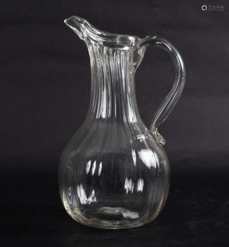 An 18th Century French wine ewer with wrythen fluted body and scrolled handle,