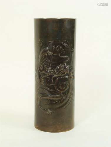 A Japanese Meiji period cylindrical bronze vase decorated a dragon in swirling clouds,