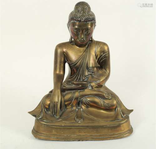 An Eastern bronze figure of a seated buddha, with right hand in Bhumisparsha Mudra,