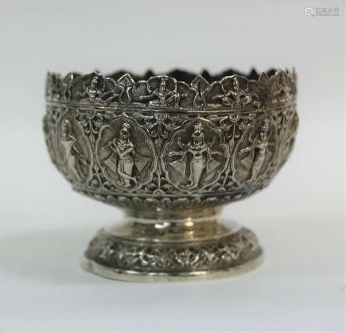 An Indian white metal bowl with crowned border depicting a surround of twelve immortals within oval