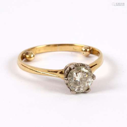 A diamond solitaire ring, claw set to an unmarked yellow metal shank, the stone approximately 0.