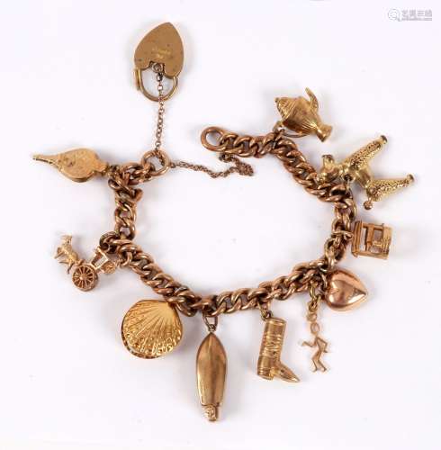 A 9ct gold charm bracelet with various charms to include a poodle, a motorboat, bellows, etc.