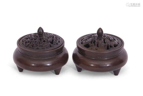 Two small Chinese bronze censers with pierced covers and six character reign mark to base, raised on