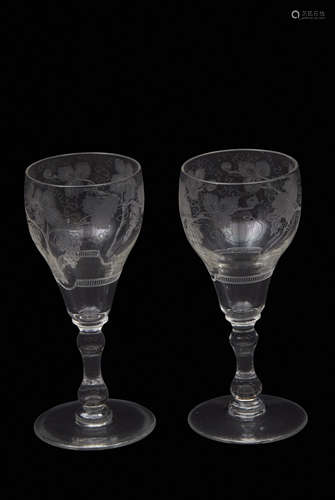 Pair of probably 18th century wine glasses, finely engraved with fruiting vines above a double