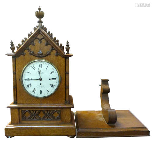 Large oak cathedral style bracket clock with matching bracket, arched top with central decorative