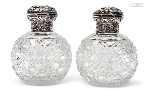 Pair of late Victorian hobnail cut oval glass scent bottles, the hinged lids and collars heavily