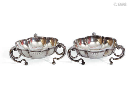 Pair of Edward VII silver bon-bon dishes of round lobed form, supported by three scroll handles