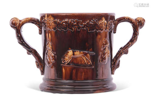 Large Staffordshire treacle glazed frog loving cup, the treacle body decorated in relief with