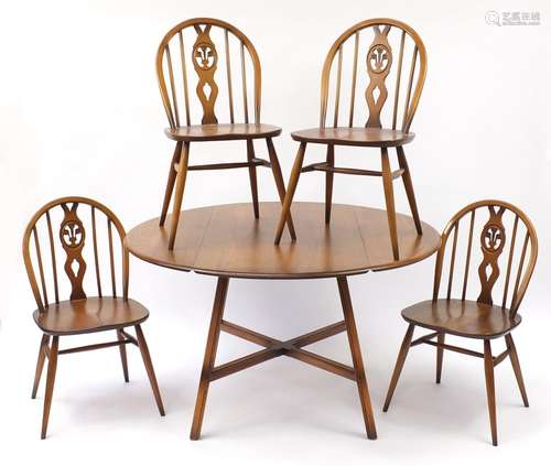 Ercol elm dining table and four chairs, the table 72cm high x 62.5cm in diameter : For Condition