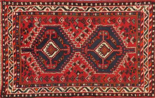 Rectangular Persian rug having an all over geometric floral design onto a red ground, 123cm x 80cm :