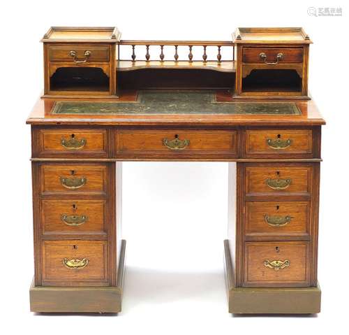 Oak twin pedestal desk with tooled leather insert and a series of drawers, 100cm H x 106cm W x