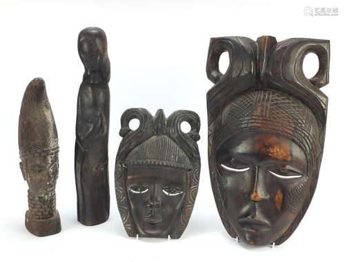 Four wood carvings including two tribal face masks, the largest 49.5cm high : For Condition