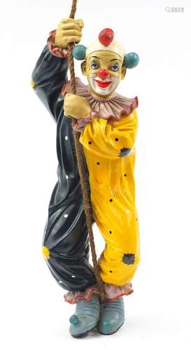 Novelty hand painted model of a clown climbing rope, 63cm high : For Condition Reports Please